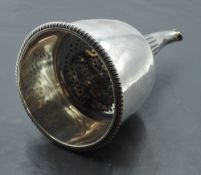 A George III silver wine strainer, of circular form with gardrooned rim and pierced grille to the