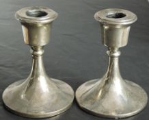 A pair of silver candle sticks of short plain circular form, Birmingham 1923, Sydney & Co, approx