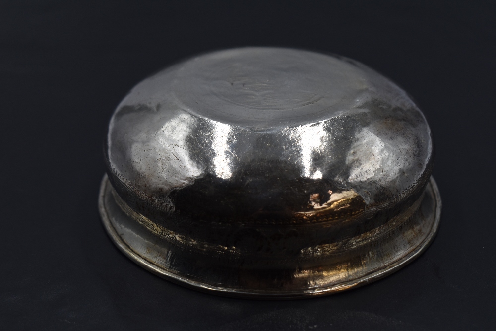A small eastern white metal dish, of circular form with flared rim, decorated with bands of - Image 2 of 3