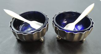 A pair of Victorian silver salts, of crimped circular form, with Bristol blue glass liners and