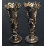 A pair of Edwardian silver bud or spill vases, having moulded and flared rims over the tapering