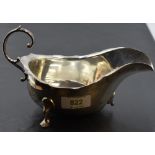 An early 20th century silver gravy boat, of generous proportions with scrolled handle and trefoil