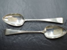 A pair of Georgian silver table spoons of Old English form bearing monogram to terminals, London