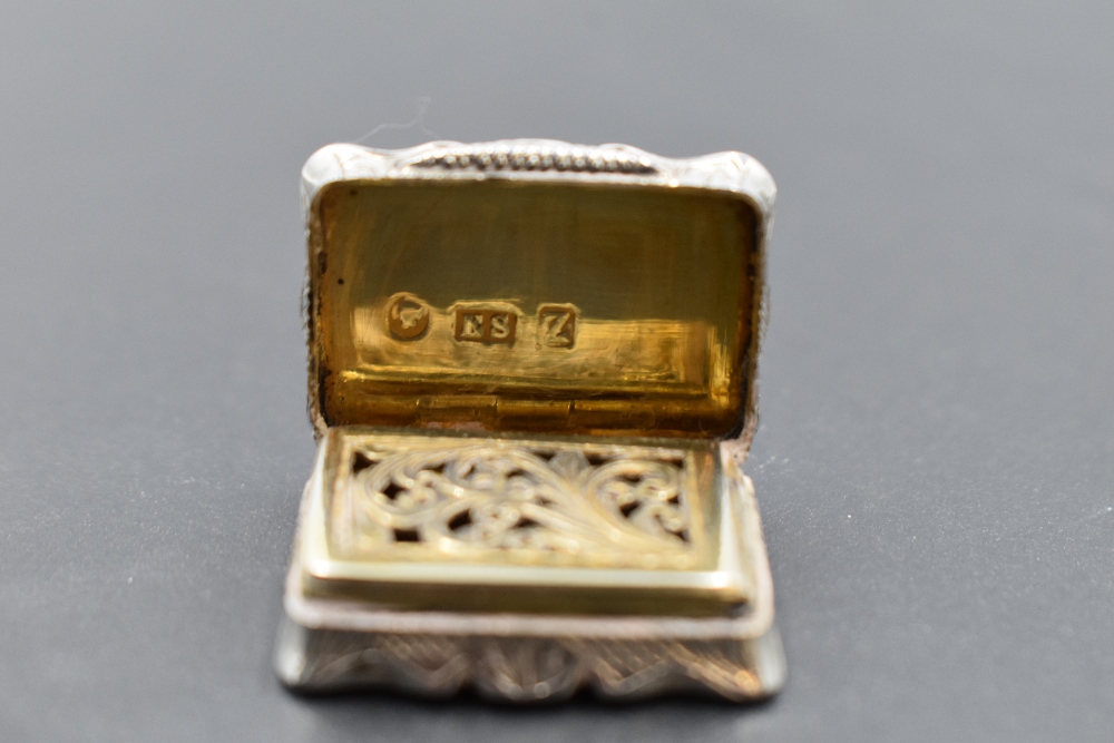 A small Victorian silver vinaigrette of shaped form having pierced gilt grill and interior, engraved - Image 3 of 3