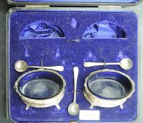 A pair of Edwardian cased silver salts, of moulded oval form with fluted cabriole type legs, marks