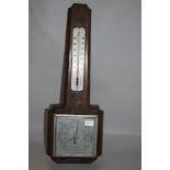 A mid century Smiths oak wall mounted barometer.