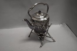 A fine antique spirit burner and kettle set having twig effect stand with embossed kettle by