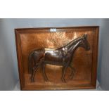 A vintage hand worked copper plaque picture of a race horse bearing signature in oak frame