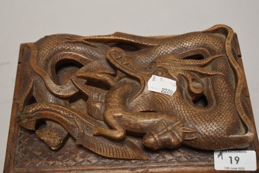 A carved wooden box having compartmental interior of Japanese style depicting dragon consuming - Image 2 of 3