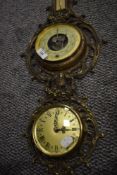 A mid century clock and barometer set having ormolu brass case