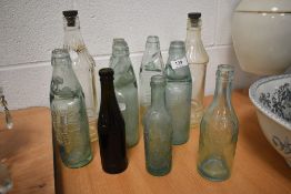A selection of vintage advertising glass bottles including Morecambe and Barrow interest