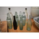 A selection of vintage advertising glass bottles including Morecambe and Barrow interest