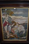 A large framed antique pictorial needlepoint depicting Moses.