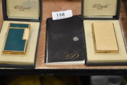Two fine and luxury cigarette lighters by St. Dupont including guilloche worked case in yellow metal