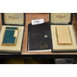 Two fine and luxury cigarette lighters by St. Dupont including guilloche worked case in yellow metal