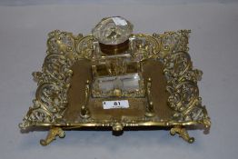 A Victorian cut glass inkwell with ornate brass tray having integrated quill rack.AF.