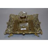 A Victorian cut glass inkwell with ornate brass tray having integrated quill rack.AF.