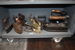 A good collection of various antique and later stove top irons including Hot Cross and Crane