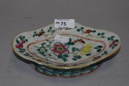 A Chinese famille rose porcelain shallow dish, of shaped oval form decorated with blossoms and