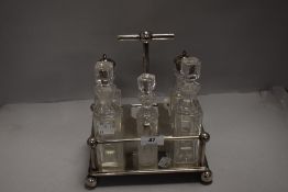 A fine art deco cruet and sauce set with chrome frame and cut glass bottles