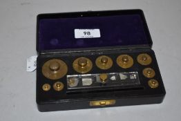 A small chemist or similar weight set having brass measures