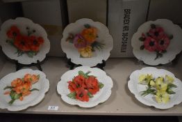 A set of six boxed Italian display plates by Capodimonte having porcelain floral designs