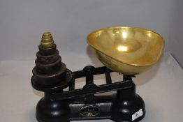 A set of modern cast iron kitchen scales by Salter with weight set