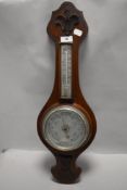 An Edwardian oak cased aneroid barometer