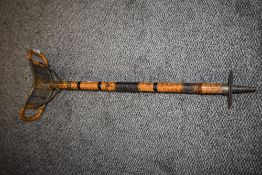 A campaign or safari style shooting stick having heavy bamboo frame with rattan seat