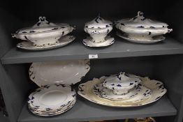An antique part dinner service having blue and white design including tureens charger etc