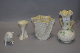 Four pieces of Irish Belleek pottery including pig figure and posy vase