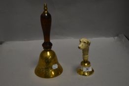 Two brass hand bells one of traditional design and one with hound head handle