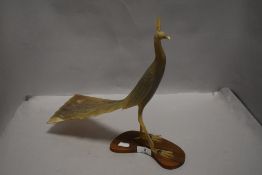 A mid century hand carved horn figure of an exotic bird or a peacock