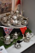 A selection of silver plated tea wares including tea pots and water jugs with caddy spoon and