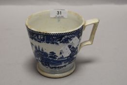 A large blue and white ware cup or mug with a traditional printed scene