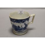 A large blue and white ware cup or mug with a traditional printed scene