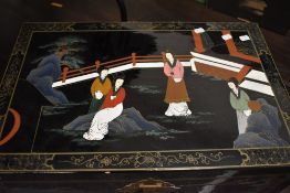 A Japanese lacquer bedding box having geisha and children playing decoration