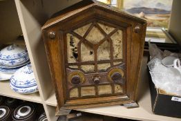 An oak cased art deco era tube radio having a gothic style case