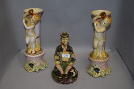 Two Capodimonte mantle vase with cherub design and a similar tramp figure Italian made