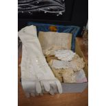 A selection of Victorian lace work and a pair of white leather gloves