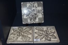 Three Victorian tiles including one bird design and two strawberry plant