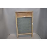 A vintage wooden framed and glass washboard