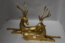 A pair of Hollywood Regency mid century mirrored brass stag statues or mantle figures