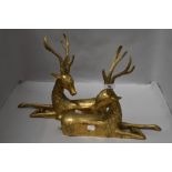 A pair of Hollywood Regency mid century mirrored brass stag statues or mantle figures