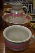 A wash jug and bowl set having white ground with pink and gilt decoration