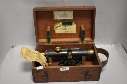 A Stanley three screw level, No 22228 in wooden case with leather handle.