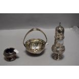 A trio of early 20th century plated ware including chase work sugar sifter, mustard pot with blue