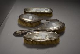 A set of HM silver Edwardian dressing table brushes in various designs