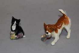 A Beswick terrier puppy with slipper and a Royal Doulton cat with tins of cat food.