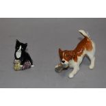 A Beswick terrier puppy with slipper and a Royal Doulton cat with tins of cat food.